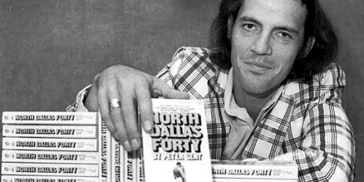 Former Dallas Cowboys flanker and author Peter Gent poses with copies of his bestseller, "North Dallas Forty," in New York. (Associated Press / August 26, 1974)