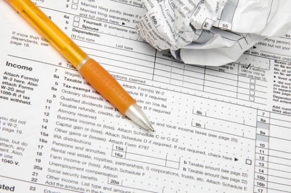 tax-forms-pen-crumpled-paper