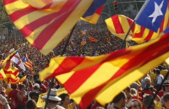People hold "estelada" flags, Catalan separatist flags, during a gathering to mark the Calatalonia day "Diada" in central Barcelona