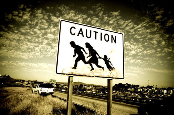 Immigrant Crossing Road Sign