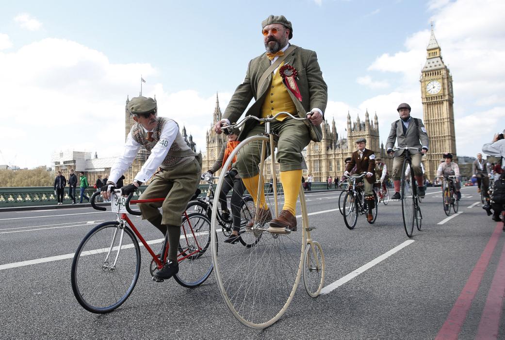 Participants in the Tweed Run ride their bicycles over Westminster Bridge in central London
