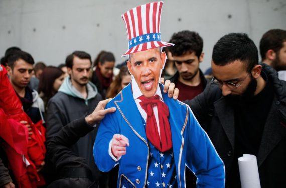 Plainclothes police officers take away an effigy of US President Barack Obama as the members of Turkey Youth Union gather to protest against the upcoming visit of Obama to Turkey mid-November for G20 summit in Antalya, outside the US consulate in Istanbul, Turkey, Sunday, Nov. 8, 2015. (AP Photo/Emrah Gurel)