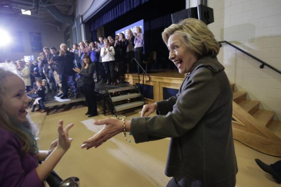 Democratic presidential candidate Hillary Clinton, right, greets people in the audience as she arrives at a town hall campaign event, Sunday, Jan. 3, 2016, in Derry, N.H. (AP Photo/Steven Senne)