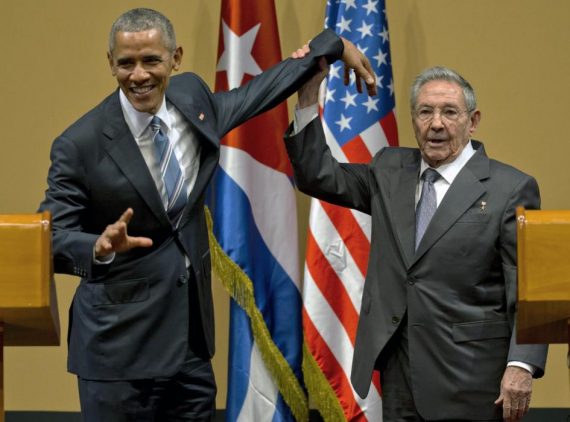 Cuban President Raul Castro, right,  tries to lift up the arm of President Barack Obama at the conclusion of their joint news conference at the Palace of the Revolution, Monday, March 21, 2016, in Havana, Cuba. (AP Photo/Ramon Espinosa)