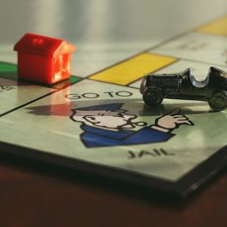 Monopoly board Go Directly to Jail with car and hotel