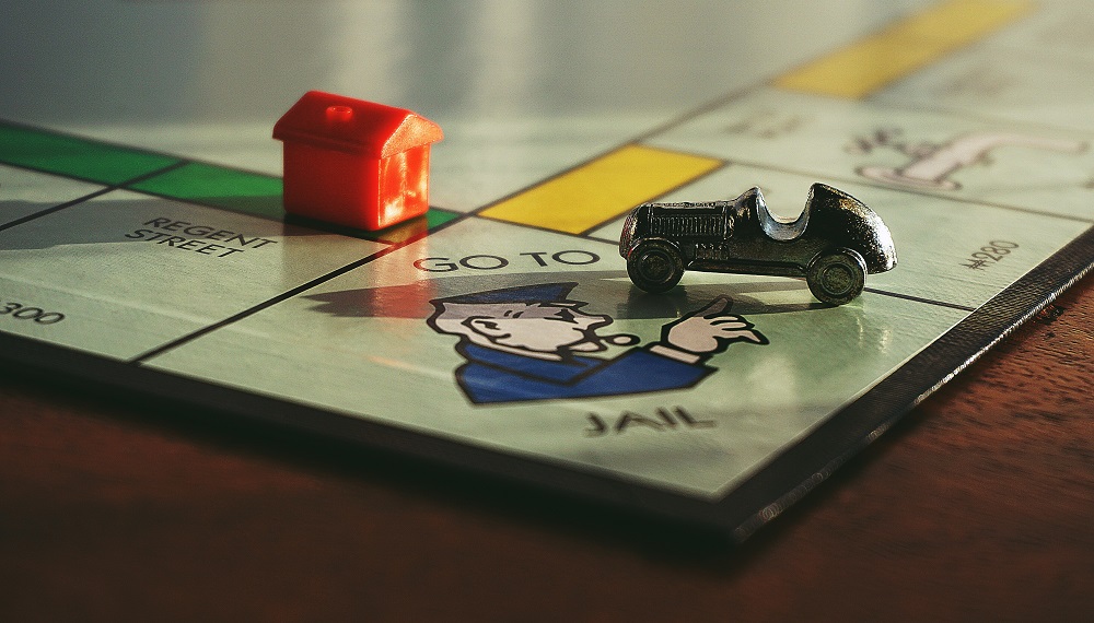 Monopoly board Go Directly to Jail with car and hotel