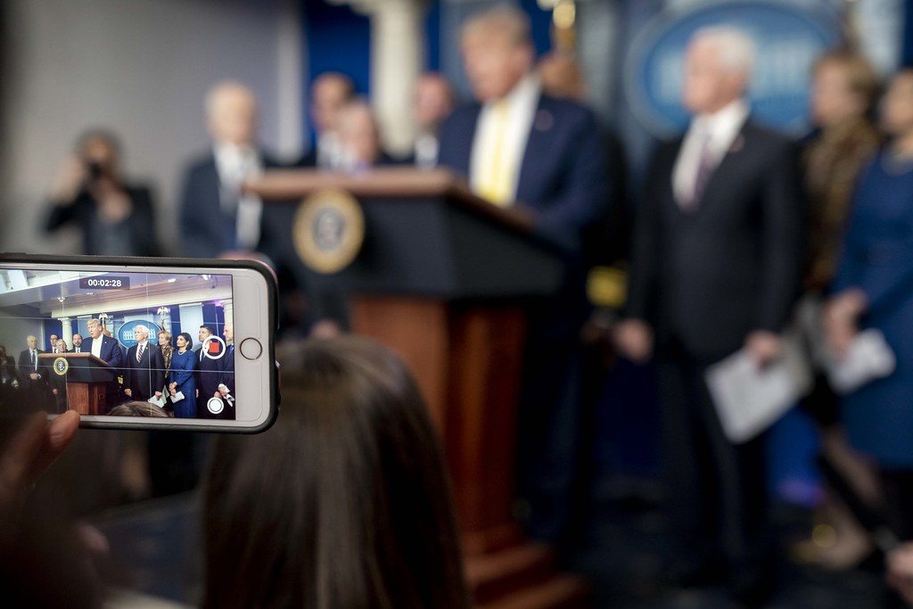President Donald J. Trump is seen on a cellphone screen as he addresses his remarks at a White House Coronavirus Taskforce update briefing Monday, March 9, 2020, in the James S. Brady Press Briefing Room of the White House. (Official White House Photo by D. Myles Cullen)