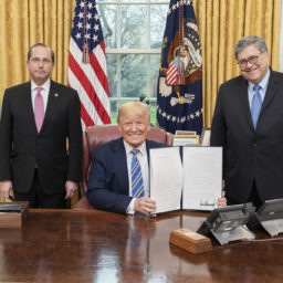 President Donald J. Trump, joined by Health and Human Services Secretary Alex Azar, left, and Attorney General William Barr, displays his signature after signing an Executive Order to Prevent Hoarding and Price Gouging, Monday, March 23, 2020, in the Oval Office of the White House. (Official White House Photo by Shealah Craighead)