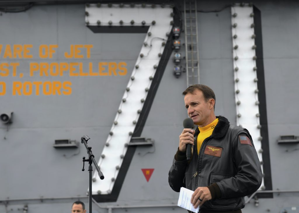 Capt. Brett Crozier, then-commanding officer of the aircraft carrier USS Theodore Roosevelt (CVN-71), addresses the crew during an all-hands call on the ship's flight deck on Nov. 15, 2019. US Navy Photo