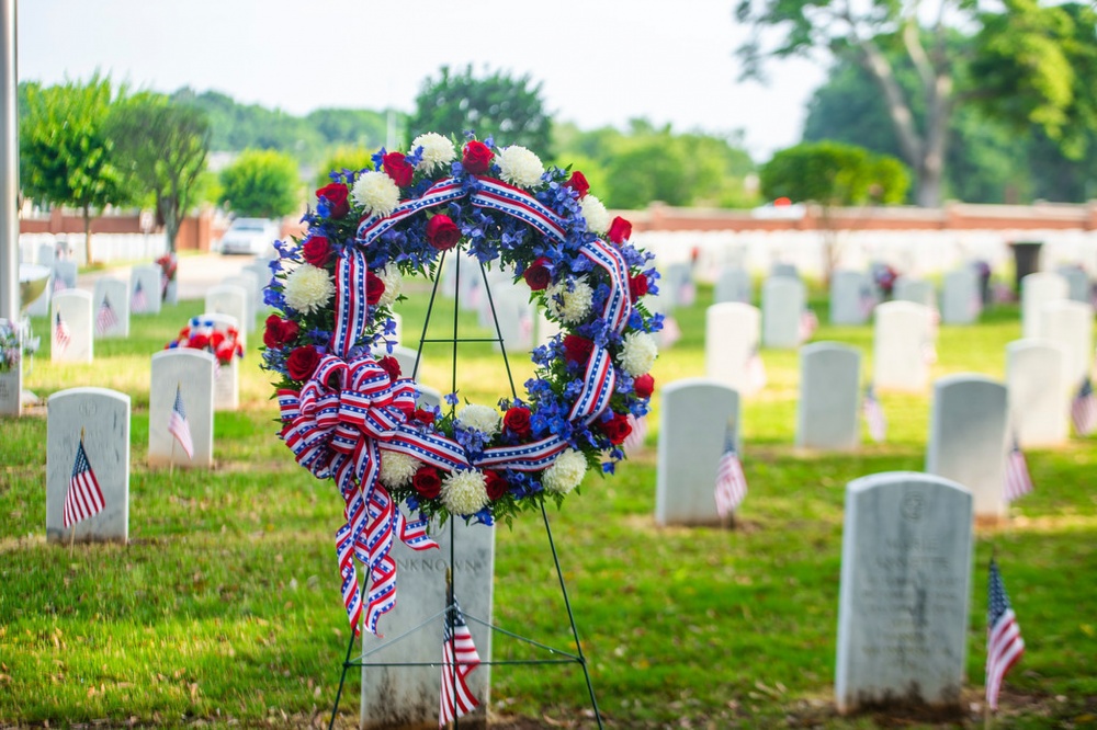 Fort Benning honors the nation's fallen service members with a Memorial Day ceremony at the post's cemetery May 27. The 9 a.m. ceremony at the Main Post Cemetery went forward under bright but partly cloudy skies, with an audience of some 200 Soldiers and civilians seated outdoors. The ceremony included remarks by a speaker, and a wreath-laying in tribute to "all the nation's veterans who made the ultimate sacrifice." The wreath-laying was followed by the firing of a three-volley rifle salute and the playing of "Taps." (U.S. Army photos by Patrick Albright, Maneuver Center of Excellence, Fort Benning Public Affairs)