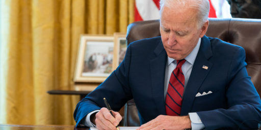 President Joe Biden signs two executive orders on healthcare Thursday, Jan. 28, 2021, in the Oval Office of the White House.