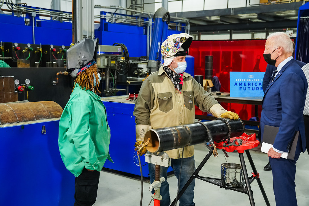 President Joe Biden observes trainers and apprentices at work at the final assembly station during a tour of Plumbers & Gasfitters Local 5 Training Facility, Wednesday, Aug. 4, 2021, in Lanham, Maryland. (Official White House Photo by Adam Schultz)