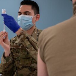 Airman 1st Class Thadyn DuPont, an aerospace medical technician with the 137th Special Operations Medical Group, prepares to administer a coronavirus vaccine for an Oklahoma National Guard soldier at the Armed Forces Reserve Center in Norman, Okla., on Jan. 15, 2021. (Andrew LaMoreaux/U.S. Air National Guard photo)