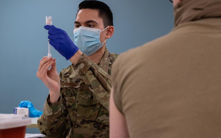 Airman 1st Class Thadyn DuPont, an aerospace medical technician with the 137th Special Operations Medical Group, prepares to administer a coronavirus vaccine for an Oklahoma National Guard soldier at the Armed Forces Reserve Center in Norman, Okla., on Jan. 15, 2021. (Andrew LaMoreaux/U.S. Air National Guard photo)