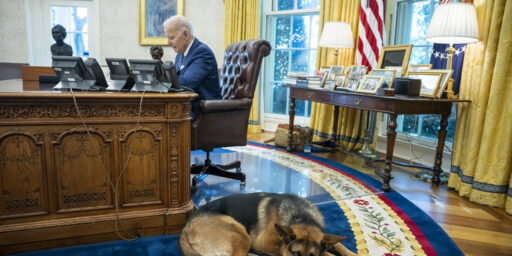 Commander waits by the Resolute Desk as President Joe Biden meets with staff in the Oval Office, Tuesday, September 27, 2022