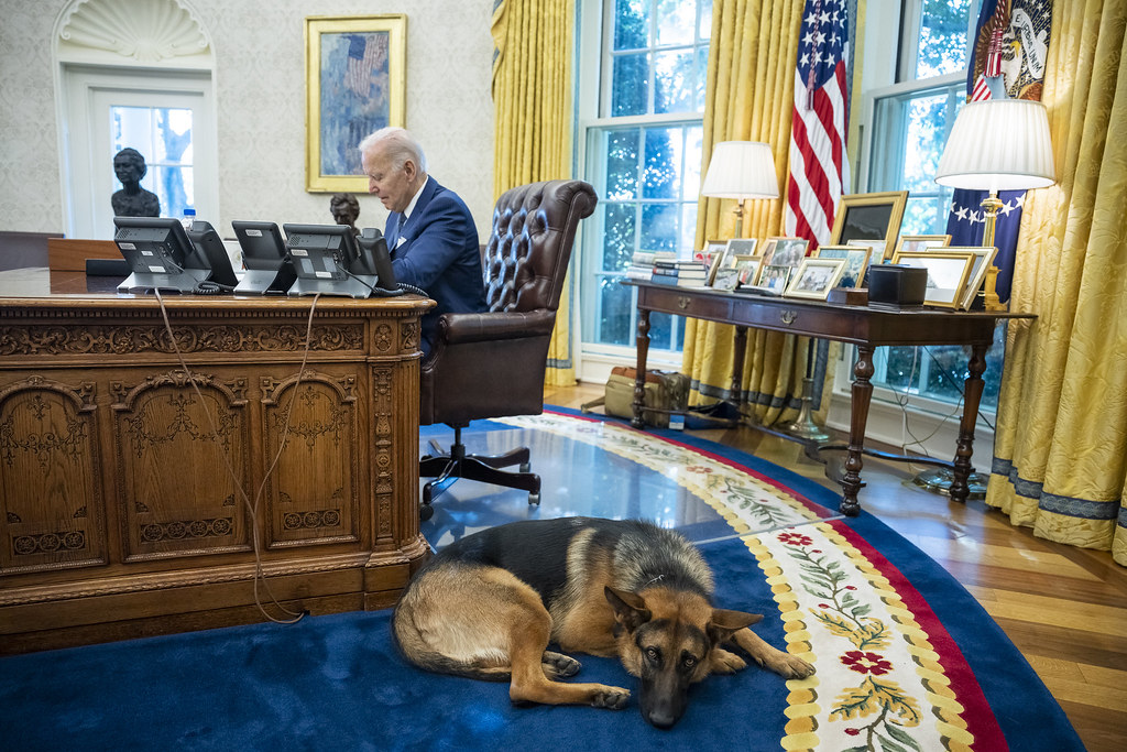 Commander waits by the Resolute Desk as President Joe Biden meets with staff in the Oval Office, Tuesday, September 27, 2022