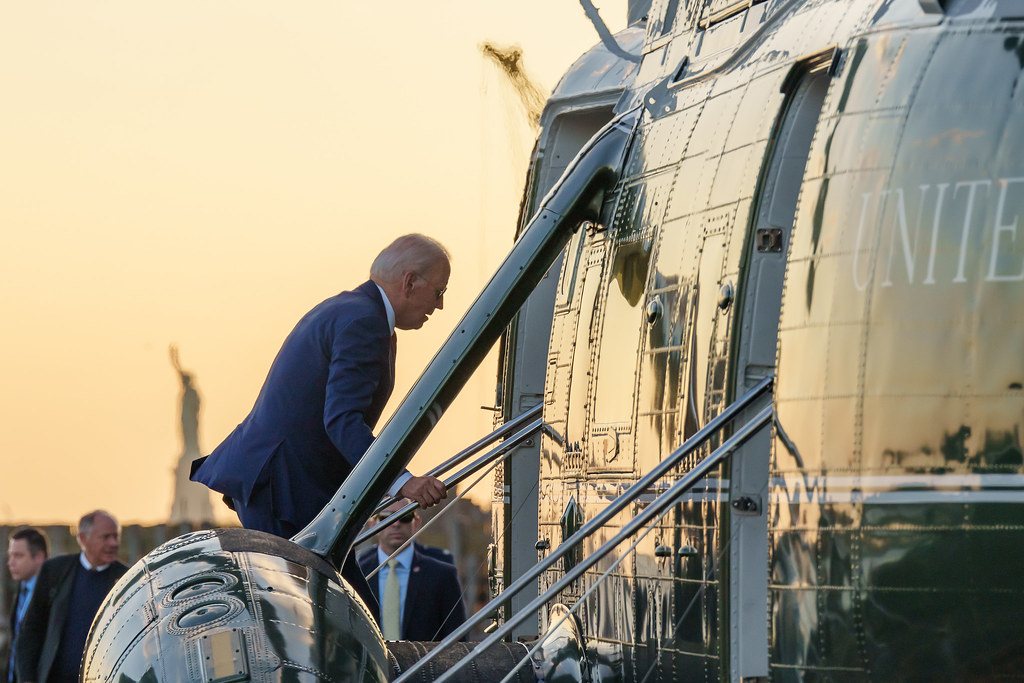 President Joe Biden boards Marine One at the Wall Street Landing Zone in Manhattan, Wednesday, Sept. 20, 2023, en route to JFK International Airport in Queens, New York.  The Statue of Liberty can be seen in the background.