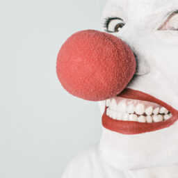 photo of man, person, white, red, artist, pink, toy, smiling, smile, makeup, mouth, close up, human body, laughing, clown, face, nose, happy, head, funny, humour, painted, organ, circus, emotion, comedy, joke, comedian, grinning, stuffed toy, joking